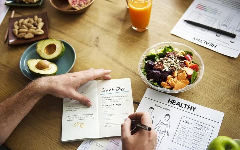 Healthy meal prep with fresh produce and a wellness journal