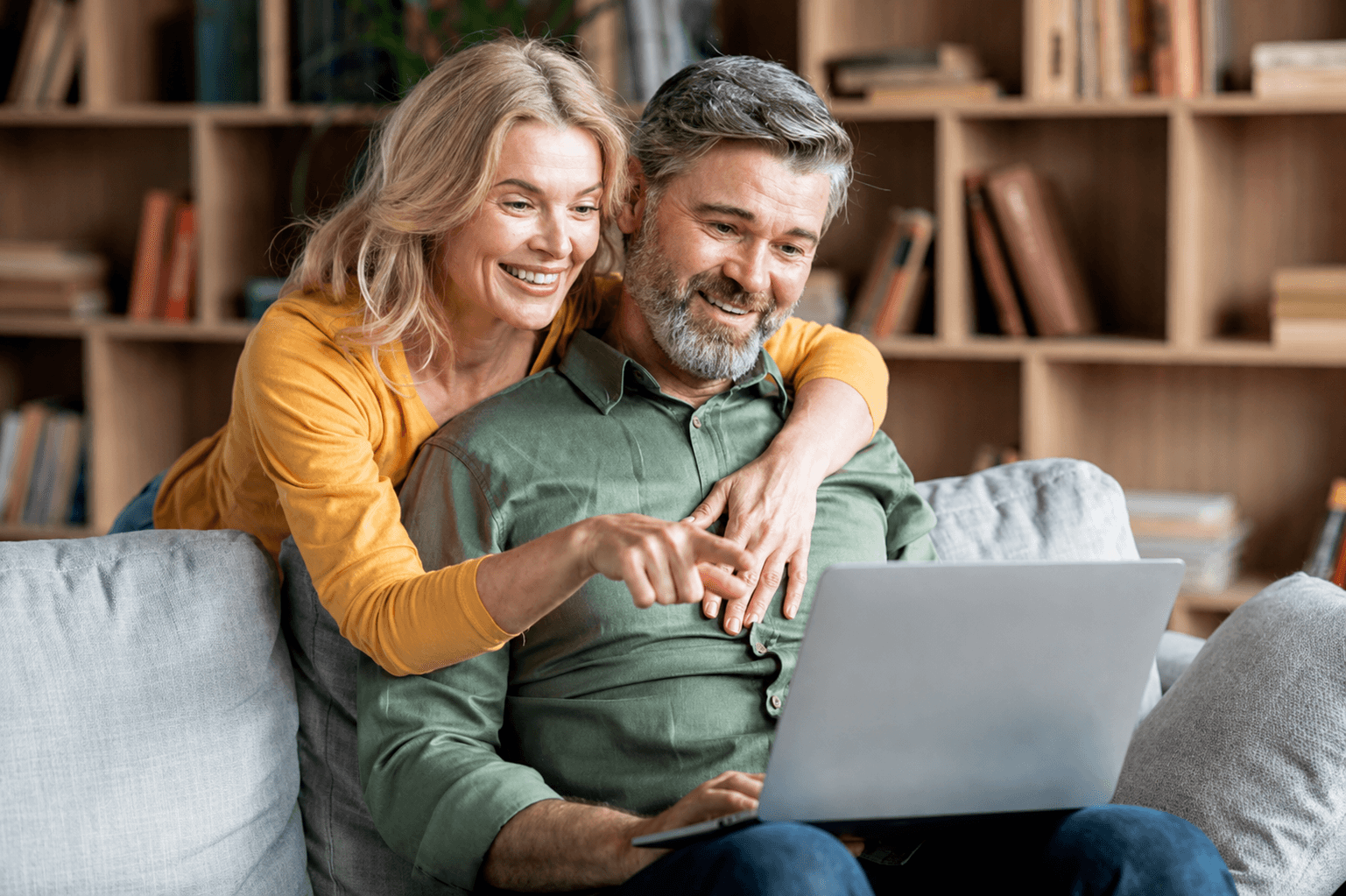 A couple reviewing their telehealth appointment together on a laptop
