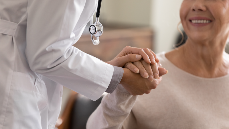 woman holding doctor's hand
