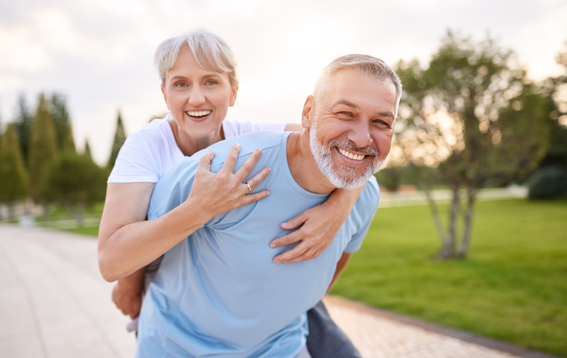 smiling elderly couple outside
