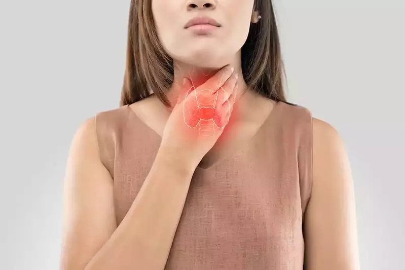 woman holding thyroid